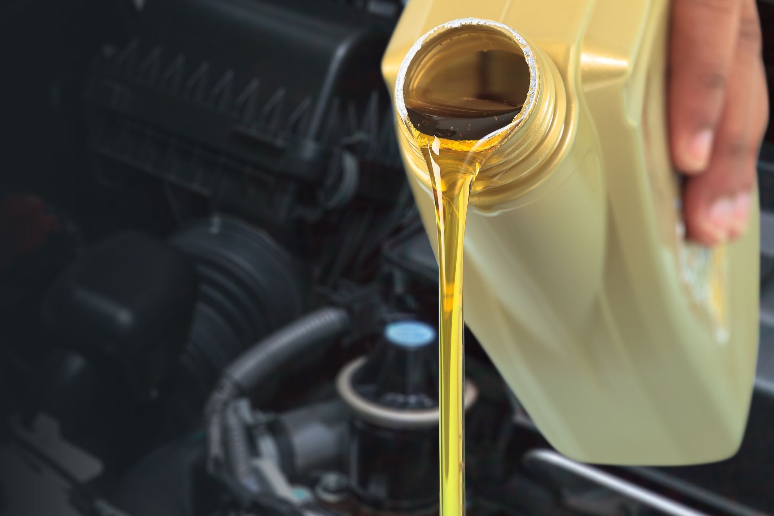 Oil being poured from a plastic container
